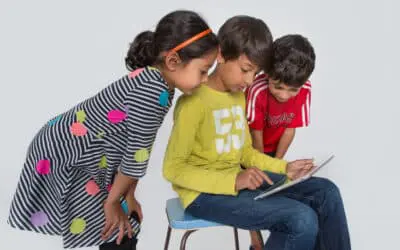 three students examine a tablet