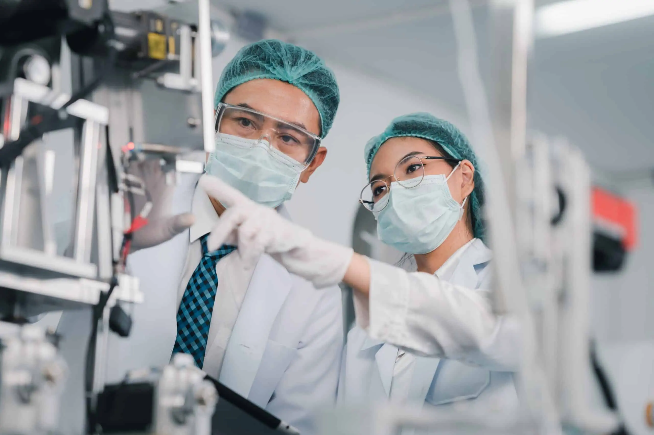 Both,Male,And,Female,Asian,Scientists,Are,Outfitted,With,Protective