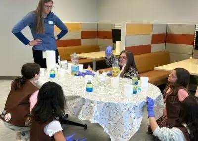 Leah Baker with Girl Scouts doing an activity