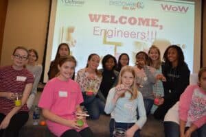 Group of girls in front of sign that says welcome engineers