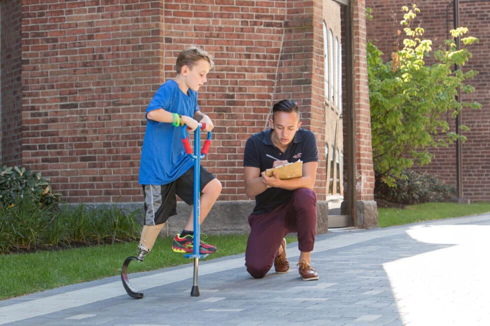 Boy With Prosthetic Steps On Pogo Stick DiscoverE