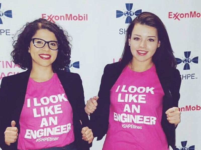 Two female engineers showing off their look like an engineer shirt